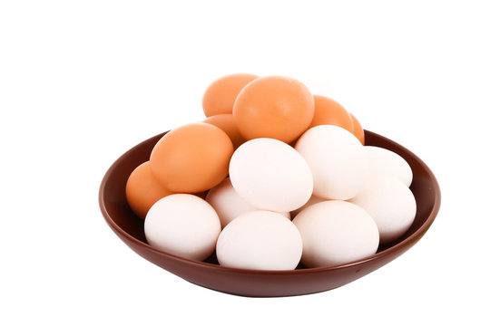 Group of brown and white hen's eggs in the plate isolated on whi