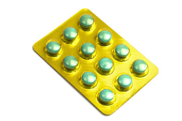 Package of green pills isolated on white