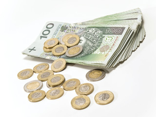 Piled polish banknotes and scattered polish coins.