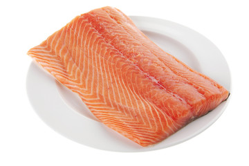 fresh uncooked salmon fillet on white plate