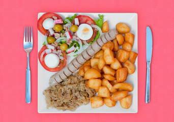 wratwurst with sauerkraut salad and potatoes
