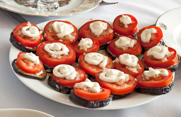 Appetizer of eggplant, tomato and garlic sauce on a plate