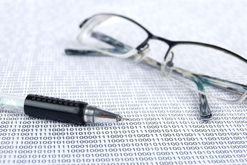 Fototapeta premium eyeglasses on binary system page