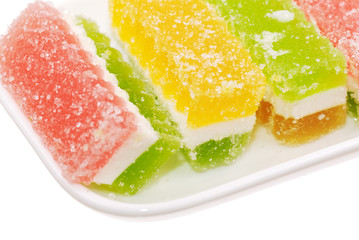 Fototapeta na wymiar Fruit candy slices on the white