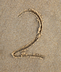 Two written in the sand at the beach