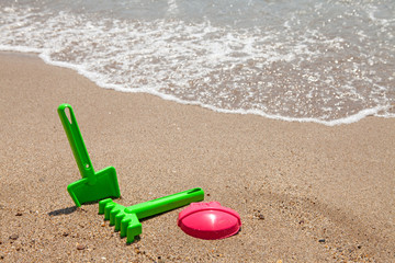 Fototapeta na wymiar plastic colorful toys at the beach