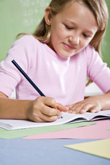 Close-up of school girl writing in notebook