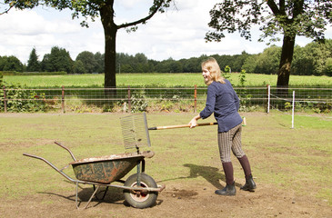 Girl cleaning the manure