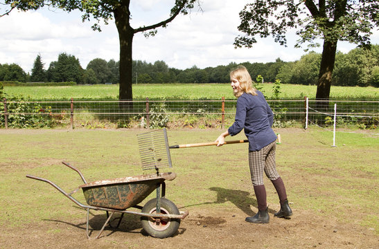 Girl Cleaning The Manure