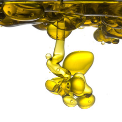 Olive oil pouring into water