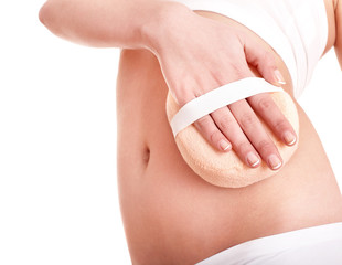Young woman scrubbing stomach.