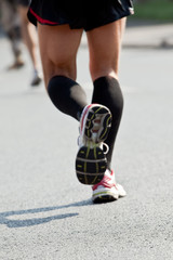 Fototapeta na wymiar Man running in city marathon - motion blur