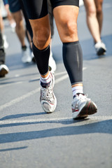 Fototapeta na wymiar Man running in city marathon - motion blur