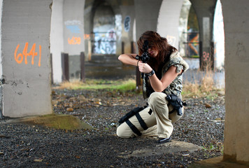 Young and sexy woman with assault rifle