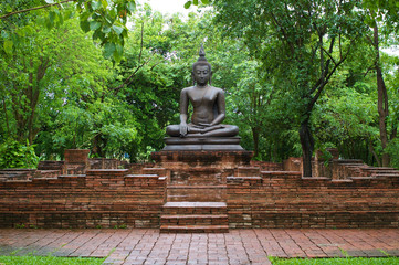 buddha statue among old brick wall