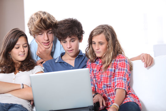 Group of teenagers at home with laptop