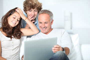 Family at home with laptop computer