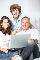 Fototapeta na wymiar Family at home with laptop computer
