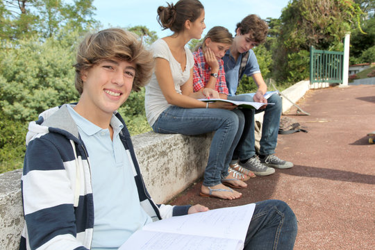 Teenagers studying outside the class