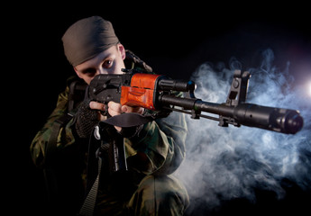 Young soldier in uniform with rifle