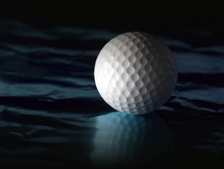 Golf ball on reflective surface