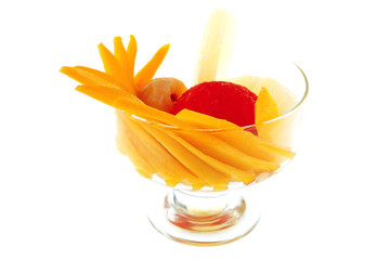 Naklejka na ściany i meble tropical fruits within small glass cup