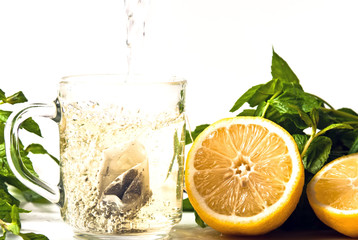 Tee wird in Glas eingegossen mit Zitrone