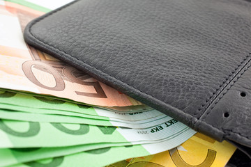 black leather wallet with euro notes