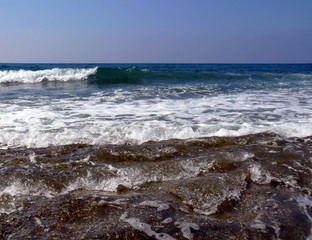 Fototapeta na wymiar Waves with white foam in the mediterranean sea