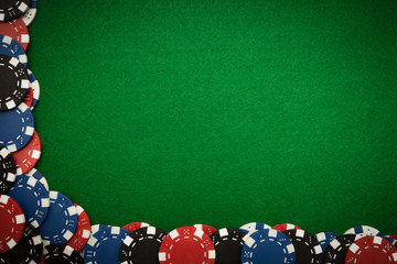 Gambling chips on green felt background