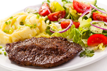 Grilled meat, boiled potatoes and vegetables