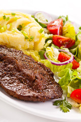 Grilled meat, boiled potatoes and vegetables