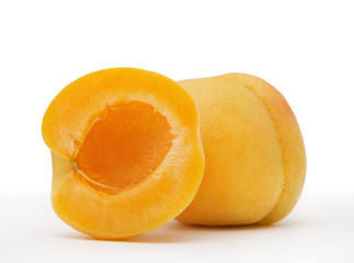 Fototapeta na wymiar Whole and half ripe apricot on white