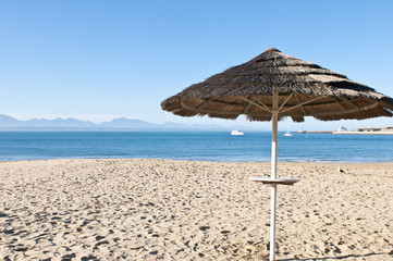 Thatched shade on a deserted beach