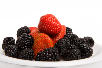 Strawberry and blackberry on the plate isolated
