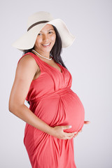 Young smiling beautiful pregnant woman in dress