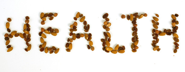 word 'health' written by almonds, hazelnuts and raisins