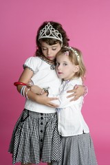 two sisters little girl friends hug stand