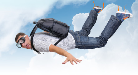 Flying man with satchel (parachute) in clouds