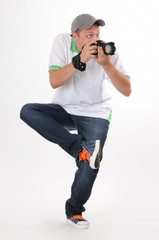 Man photographer with camera in funny pose on withe background