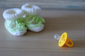 Baby's bootees and pacifier