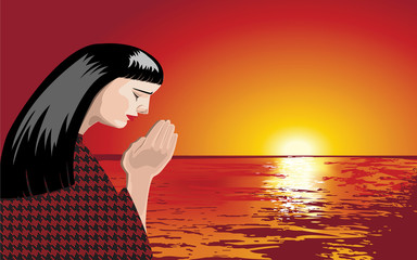woman praying at sunset
