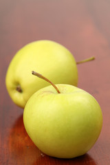 Green organic apples on a table. Shallow dof
