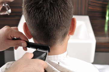 Barber cutting hair with scissor