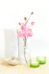 Composition of Pink orchid, towel and two candles