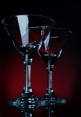 two martini glass stay on a red bg