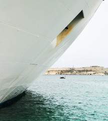 Ship's hull and Luzzu in Grand harbour