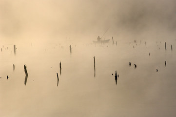 A fisherman in a boa.t Early morning.