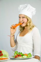 girl with salad, eating a carrot