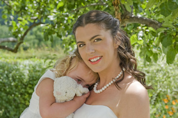 Bride and Young Bridesmaid in the garden on the wedding day